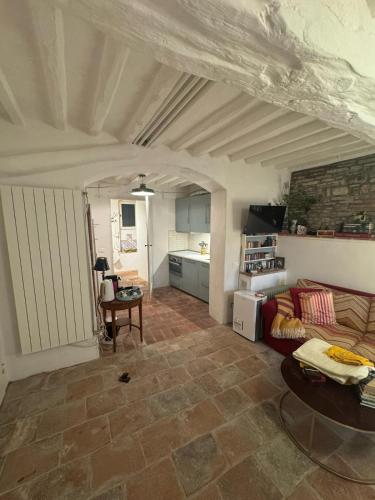 a living room with a couch and a kitchen at Authentic Tuscan Studio in Lucca with Private Patio in Lucca