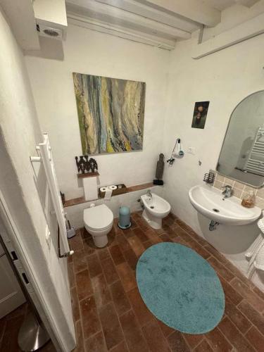 a bathroom with a sink and a toilet and a mirror at Authentic Tuscan Studio in Lucca with Private Patio in Lucca