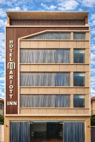a building with a sign on the side of it at Hotel Mariott Inn in Prayagraj