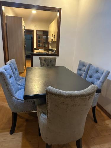 a dining room table with two chairs and a mirror at Dash-8 in Kigali