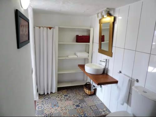a white bathroom with a sink and a toilet at El aceitunal private pool in Puerto del Rosario
