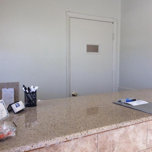 a counter top with a door in a room at Regency Inn Comanche in Comanche