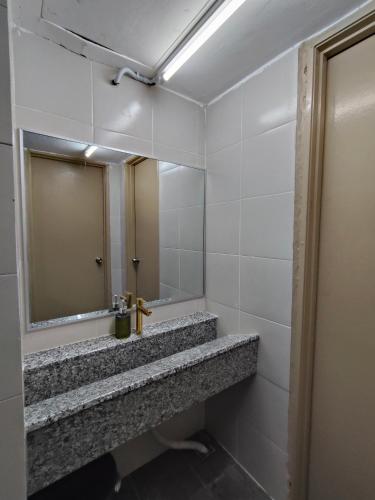 a bathroom with a sink and a mirror at Kayangan Suite - Home Studio in Kangar