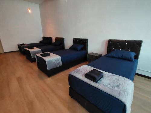 a living room with two couches and a couch at Kayangan Suite - Home Studio in Kangar