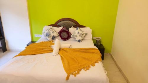 a bed in a room with a green wall at Rajdhani Resort Lonavala in Lonavala