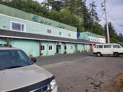 a white van parked in front of a blue building at The Orca Inn in Alert Bay