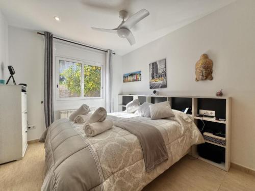 a bedroom with a large bed with a ceiling fan at Villa Aura en Platja d'Aro in Platja d'Aro
