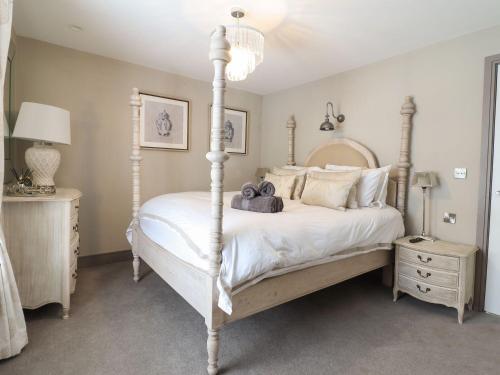a bedroom with a white bed with a four posts at 2 Llewelyn Street in Conwy