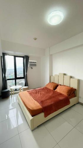 a bedroom with a large bed and a large window at Arc Tower Condominium 1930 and 1727 in Cebu City