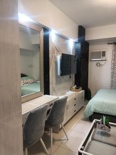 a bedroom with a mirror and a sink and a bed at Arc Tower Condominium 1930 and 1727 in Cebu City