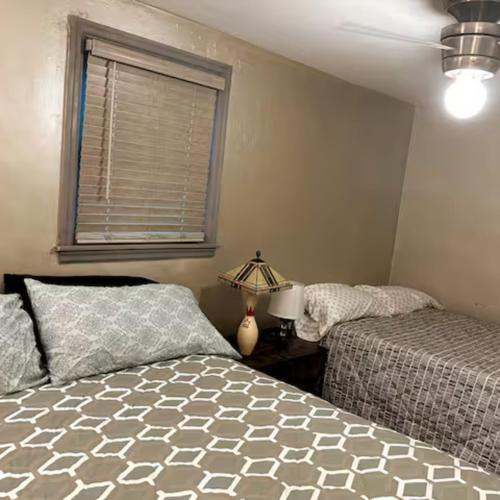 a bedroom with two beds and a window at Economy 3 beds in Moorhead