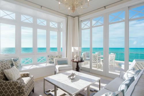 a living room with a view of the ocean at The Shore Club Turks & Caicos in Grace Bay