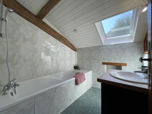 a bathroom with a bath tub and a sink at Xuhinxaharea in Banca