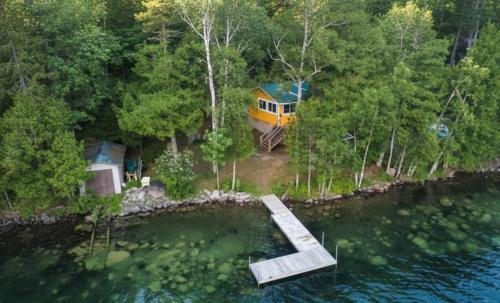 an aerial view of a house in the woods next to the water at Spa by Lake Edja - Chalet Yellow Mellow in Messines