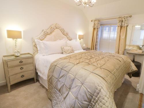a bedroom with a bed and a dresser and a window at 8 Crown Lane in Conwy