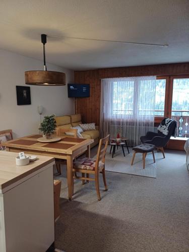 a kitchen and living room with a table and chairs at Studio Le Cocon in Champéry