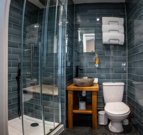 a bathroom with a toilet and a sink and a shower at The Oakwood Hotel in Gloucester