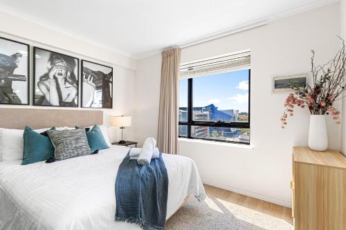 a bedroom with a bed and a large window at Walk & Wander - A Sepal Stay in Perth