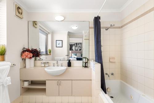 a bathroom with a sink and a tub at Walk & Wander - A Sepal Stay in Perth