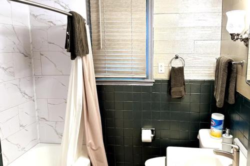a bathroom with a shower and a toilet and a sink at Economy 3 beds in Moorhead