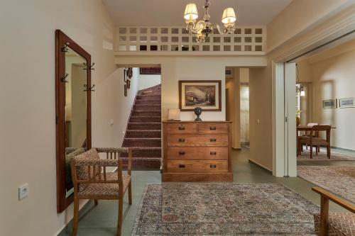 a hallway with a staircase and a dresser with a mirror at Vava Residence in Heraklio