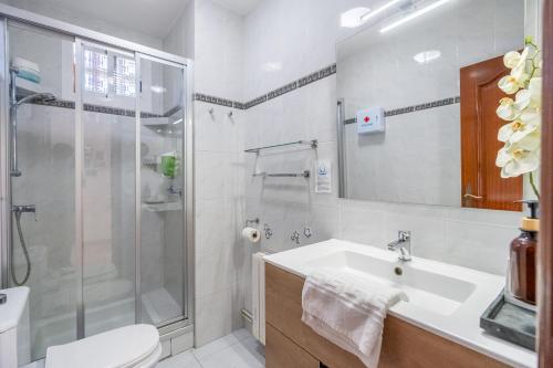a bathroom with a shower and a sink and a toilet at Villa Les Moreres de Sitges in Sitges