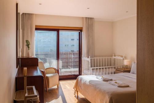 a hotel room with a bed and a balcony at Spacious Seafront Residence - Family Friendly in Vila Nova de Gaia