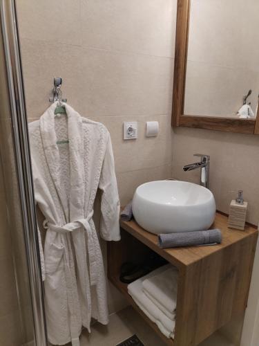 a bathroom with a white sink and a mirror at Iasskii Torg - La belle epoque in Iaşi