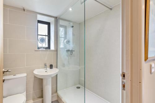 a bathroom with a shower and a toilet and a sink at 3 Bed in Hayle oc-78551 in Hayle