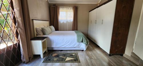 a small bedroom with a bed and a window at Westbrook Hideaway in Westbrook