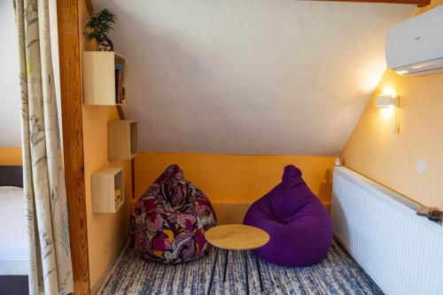 a room with two bean bags and a table at Вила Карапча in Stoyan Zaimovo