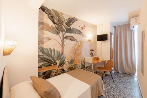 a hotel room with a bed and a table at Hotel BH Los Ángeles in Benidorm