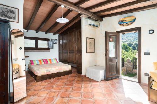 a bedroom with a bed in a room with a window at Casa Bados in Dorgali