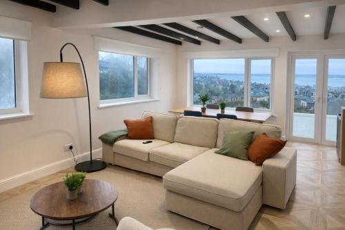 a living room with a couch and a table at Valdermosa in Newlyn