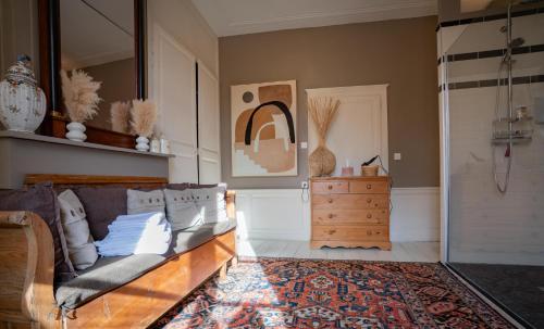 a living room with a couch and a dresser at Le Palais de la Cathédrale in Saint-Omer