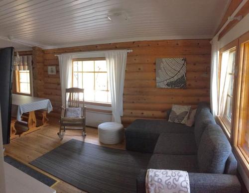a living room with a couch and a table at Kangasjärvi in Pudasjärvi