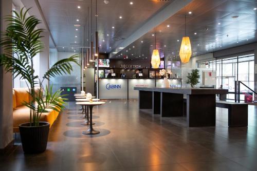 a lobby with a bar and a potted plant at Cabinn Aarhus in Aarhus