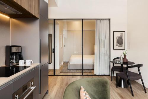 a room with a kitchen and a bedroom with a bed at Eurostars Old Montreal Suites & Apartments in Montreal