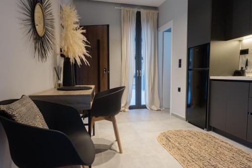 a dining room with a table and chairs and a clock at Loft 77 Patras in Patra