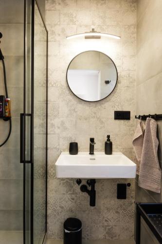 a bathroom with a sink and a mirror at Apartment Spišská Nová Ves in Spišská Nová Ves