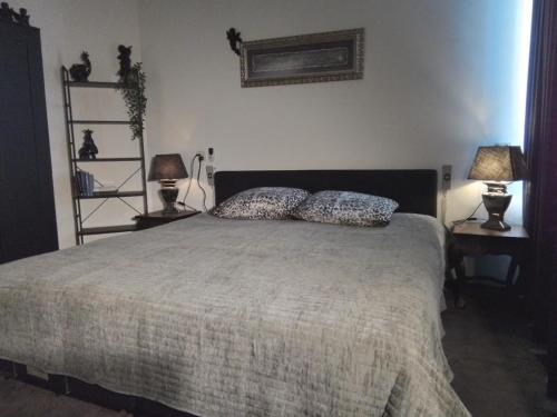 a bedroom with a bed with two pillows on it at D'n Engel in Sittard