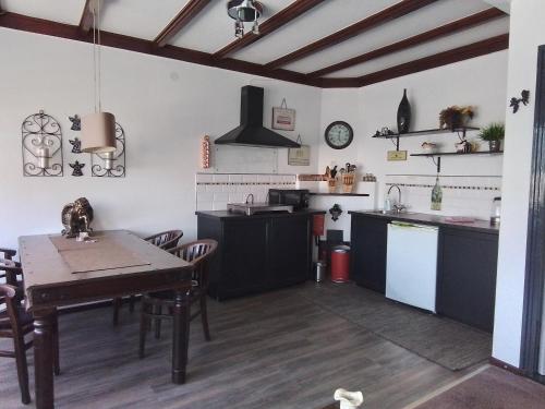 a kitchen with a table and a dining room at D'n Engel in Sittard