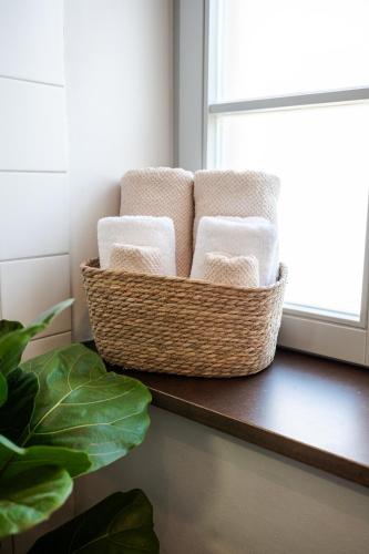 a basket of towels sitting on a table next to a window at Buhlsche Mühle in Ettlingen