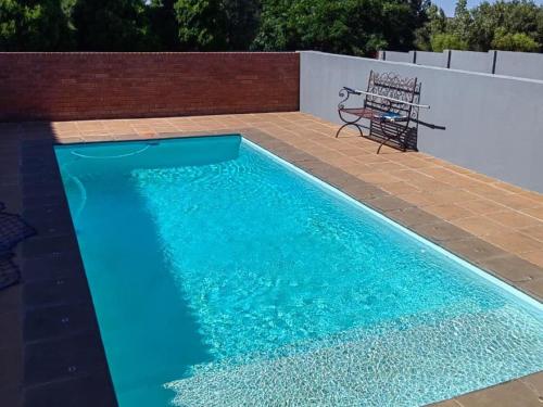 a blue swimming pool with a bench next to it at 2nd Cozy Corner in Highlands
