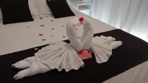 two swans wrapped in towels on a bed at Venezia Aparts in Colón