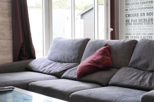 a couch with two pillows on it in a living room at Le Petit Orme in Chartres