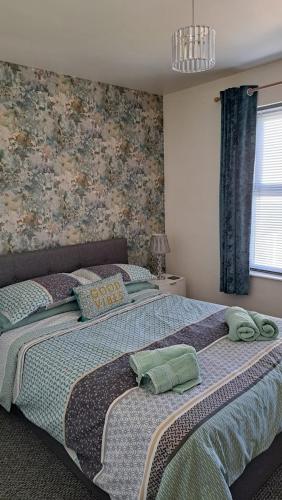 a bedroom with a bed with towels on it at Rock Quay in Killyleagh