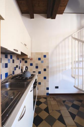 a kitchen with a sink and a stove top oven at Casa Angela Apartments in Bergamo