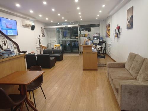 a living room with a couch and a table at Hotel Paulista in Porto