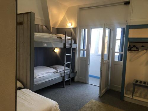 a room with two bunk beds and a hallway at AUBERGE RIVA BELLA in Le Touquet-Paris-Plage